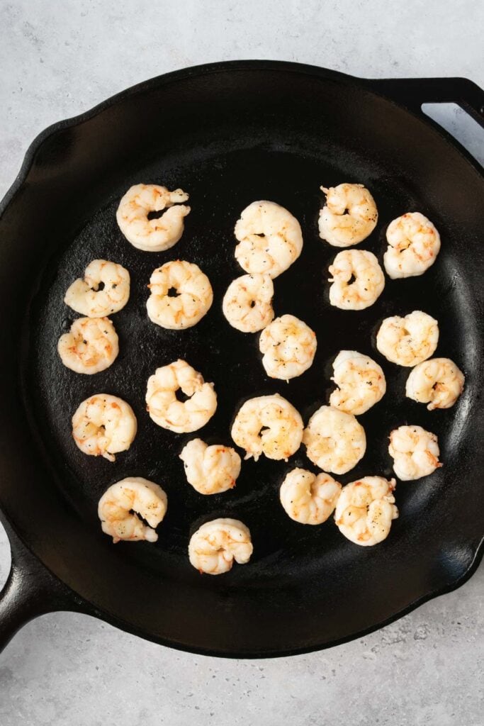 shrimp cooking in a cast iron skillet.