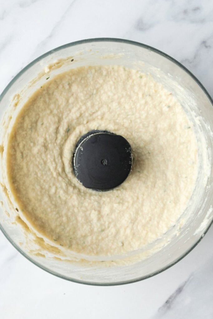 blended white bean dip in a food processor bowl. 