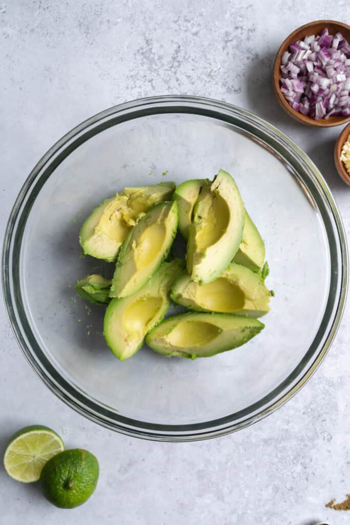 a bowl with slices of avocado.