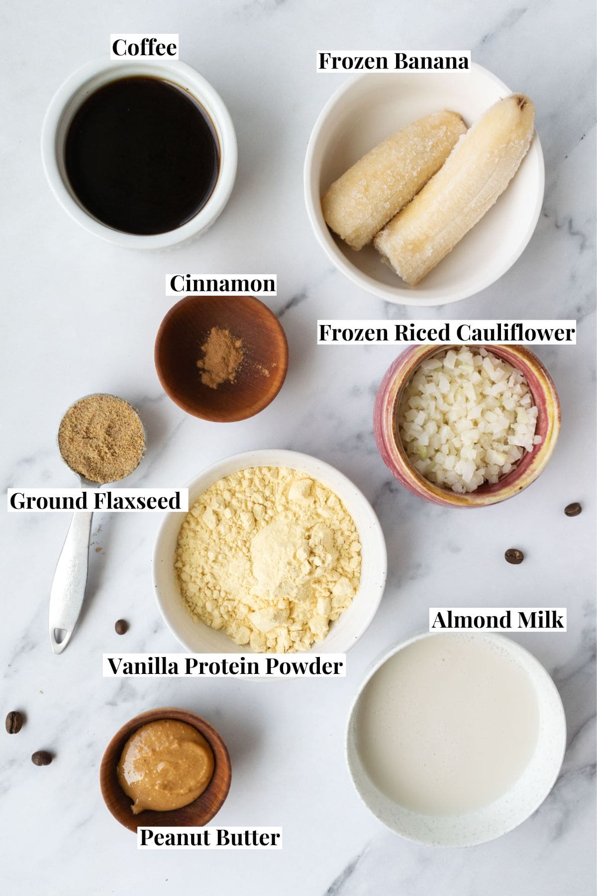 smoothie ingredients in bowls and measuring spoons.
